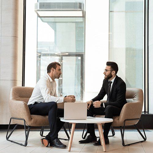 Two professionals in a candid coaching conversation